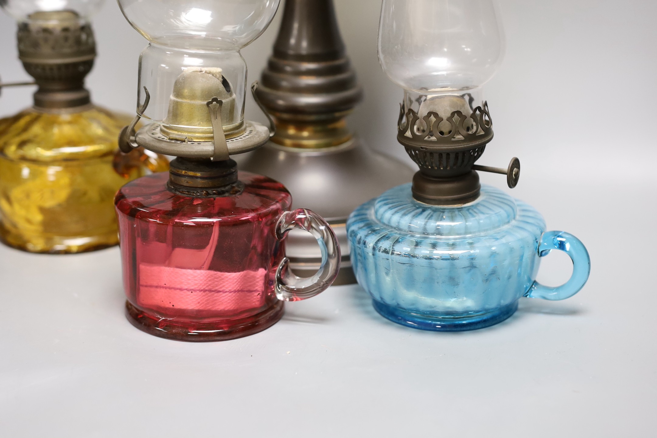 A Victorian oil lamp with vaseline glass shade and three small oil lamps, large oil lamp 49 cms high